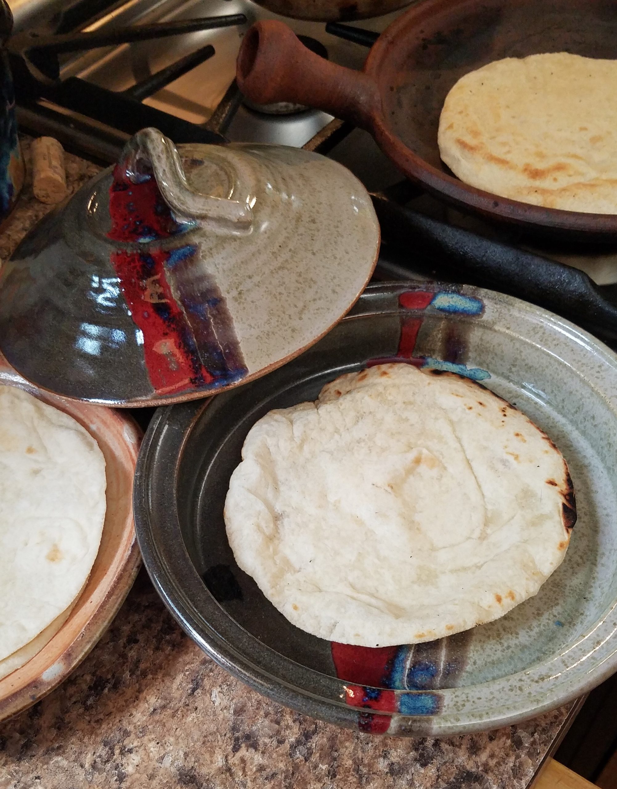 https://newclaypottery.com/wp-content/uploads/2019/07/Serving-Tortilla-Lid-comal-scaled.jpg